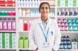 © Krakenimages.com - Young beautiful hispanic woman pharmacist smiling confident standing at pharmacy