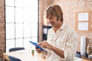 Poster - Young man business worker using touchpad at office