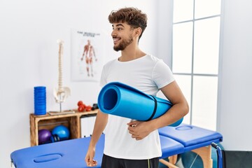 Sticker - Young arab man patient smiling confident holding yoga mat at clinic