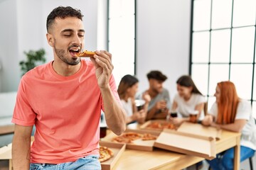 Sticker - Group of young people smiling happy eating italian pizza sitting on the table at home