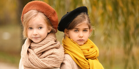 Poster - Cute little girls in autumn clothes outdoors