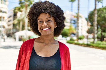 Wall Mural - Young african american girl smiling happy standing at the city.