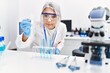 © Krakenimages.com - Middle age grey-haired woman wearing scientist uniform using pipette at laboratory