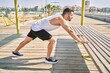 © Krakenimages.com - Hispanic man stretching after working out outdoors on a sunny day