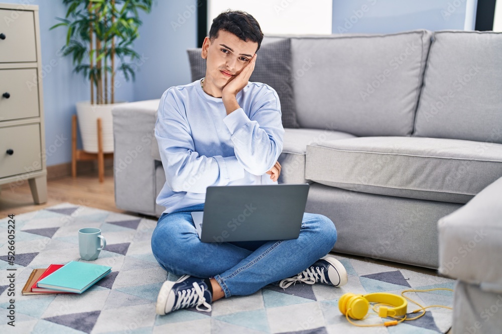 Non Binary Person Studying Using Computer Laptop Sitting On The Floor Non binary person studying using computer laptop sitting on the floor