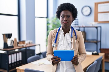 Poster - African young woman wearing doctor stethoscope skeptic and nervous, frowning upset because of problem. negative person.