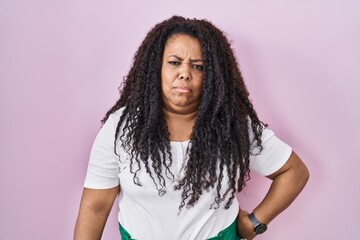 Sticker - Plus size hispanic woman standing over pink background depressed and worry for distress, crying angry and afraid. sad expression.