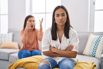 Two women mother and daughter arguing at home