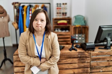 Poster - Young down syndrome woman working as manager at retail boutique with hand on stomach because nausea, painful disease feeling unwell. ache concept.