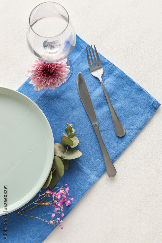 Simple table setting with floral decor on white background