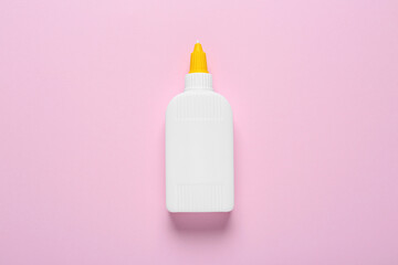 Wall Mural - Bottle of glue on pink background, top view