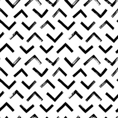Wall Mural - Vector seamless pattern with triangular lines. Ethnic or tribal chevron ornament zig zag and triangular brush strokes. Geometric textured grunge pattern for wallpaper, fabric print, wrapping paper. 