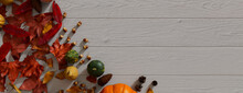 Seasonal Background, With Fall Leaves, Gourds And Fruits On A White Wood Surface. Thanksgiving Concept With Copy Space.
