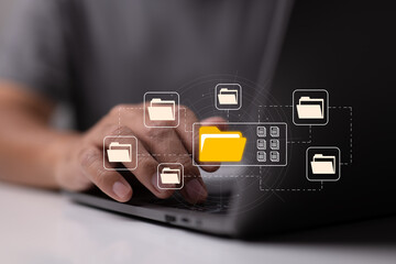 Leinwandbilder - E-documents enable paperless offices. A businessman types on a laptop while examining virtual document icons.