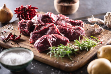 Wall Mural - Beef shank for stew cut to big chunks with herbs, spices, salt and vegetables ready for cooking