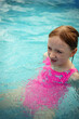 © Анна Молько - A child in the water. A girl splashes in an inflatable pool in the garden on a sunny summer day. High quality photo