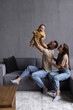 © F8  \ Suport Ukraine - Happy young parents play have fun with excited little son in living room.