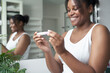 © gpointstudio - Happy African-American  woman holding pregnancy test results