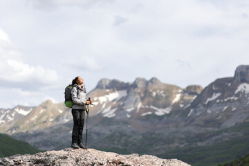 Wall Mural - Full body of a hiker breathing fresh air in a high mountain