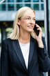 © Westend61 - Smiling businesswoman with blond hair talking on phone