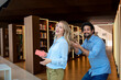 © Westend61 - Cheerful man playing with colleague's hair in library