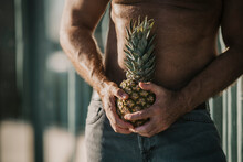 Shirtless Mature Man Holding Pineapple