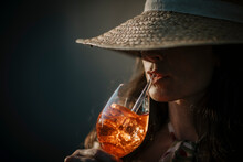 Woman Wearing Hat Having Drink With Straw