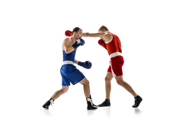 Dynamic portrait of two professional boxer in sports uniform boxing isolated on white background. Concept of sport, competition, training, energy