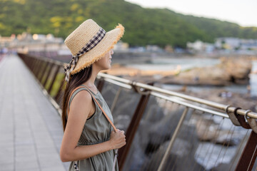 Wall Mural - Travel woman enjoy the sea view under sunset