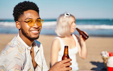 Black Man Drinking Beer With Friends