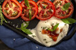 © ADDICTIVE STOCK - Delicious dish with tomatoes cheese and herbs on tray