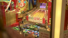 Arcade Coin Pusher, Woman Pointing At Where To Drop The Coin, Slow Motion