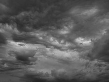 Black White Sky With Clouds. Dramatic Cloudy Sky Background For Design. Dark Gray Cloudscape. Wind Before The Storm. Ominous Oppressive Atmosphere.