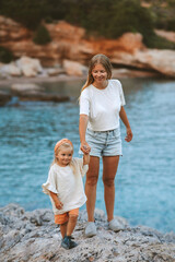 Mother and daughter walking outdoor travel together summer vacations lifestyle woman with child on beach mothers day