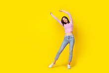 Full Length Photo Of Nice Young Girl Dancing Enjoy Party Weekend Relax Wear Stylish Striped Garment Isolated On Yellow Color Background