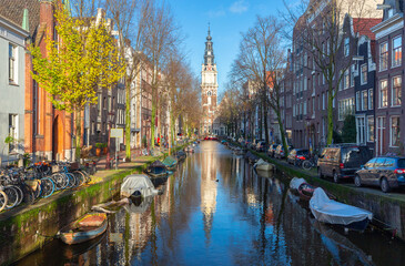 Wall Mural - Beautiful old houses on the city waterfront of Amsterdam on a sunny day.