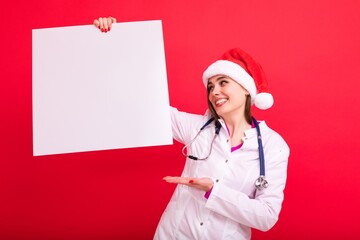 Christmas mockup. Nurse with a white poster on a red background