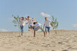 © aletia2011 - Family playing football on a beach in summer day