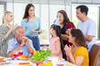 © kunchainub - surprise granddaughter with chocolate cake for birthday party with group of happy and smile family at home after dinner meal with many food for celebration