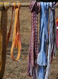 Fototapeta  - Assortiment de rubans plats tissés aux couleurs vives, pouvant servir de ceintures