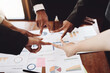© Jirapong - Group of business people showing merger symbol, together concept