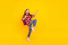 Photo Of Sweet Funky Schoolgirl Wear Checkered Shirt Walking Rising Fists Isolated Yellow Color Background