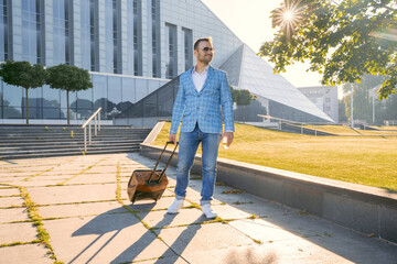 Shot of professional businessperson with baggage walking in city after arriving.