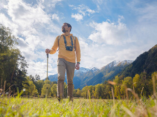 Wall Mural - trip to Caucasus mountains, Arkhyz, Teberdinsky reserve. concept of discovery and exploration of wild places in early autumn. Man hiking in mountains with backpack and photo camera