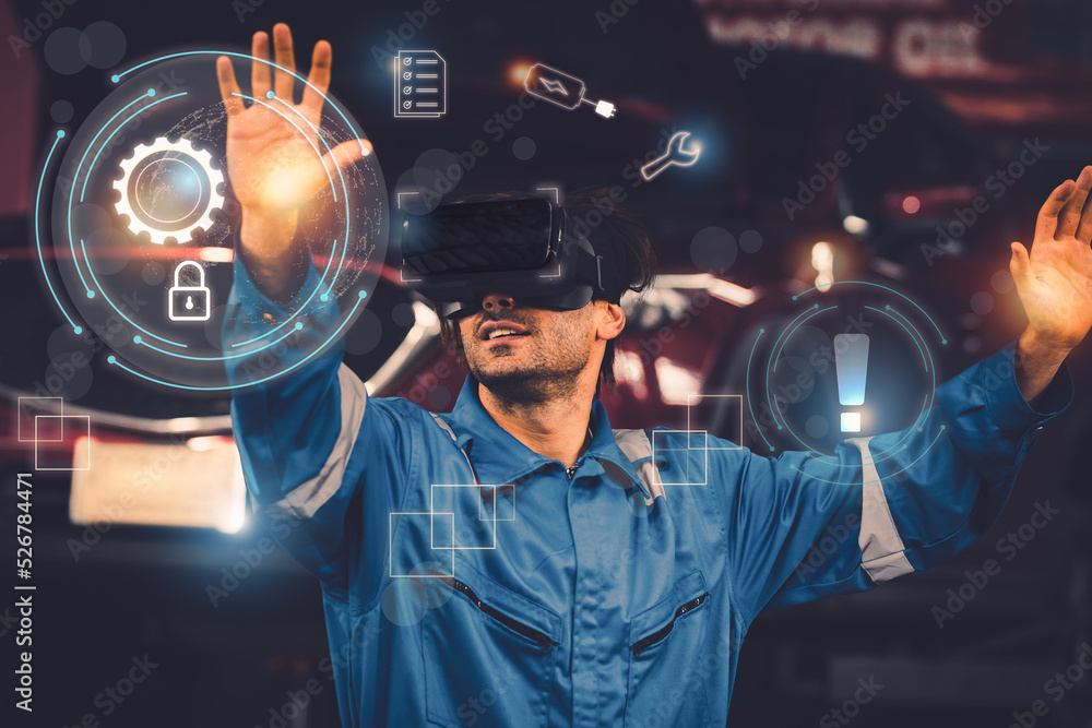 Mechanic wearing uniform, VR virtual reality glasses to analyze, repair ...