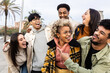 © Xavier Lorenzo - Group of happy friends laughing and hanging out outdoor - Multiracial young people having fun together during travel vacation in city street