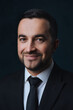 © Serhii Savchenko - Close-up portrait of a smiling modern man in a fashionable suit, a man in a black suit on a dark background