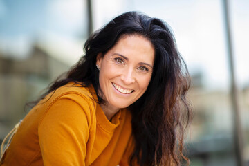 portrait of beautiful caucasian woman smiling outdoors