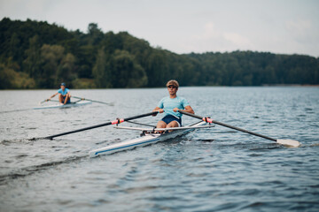 Sportsman oarsman single scull man rower rowing on boat oars.