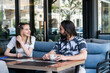 © rastockinc - \Young couple sitting at the cafe and looking at each other